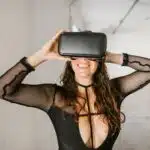 Smiling Woman in Black Top Wearing Virtual Reality Goggles